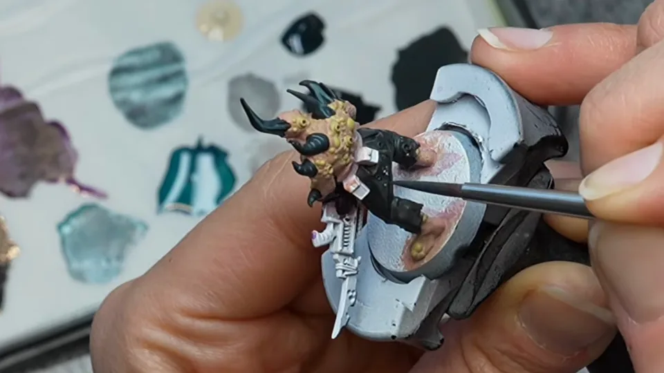 Her brush laying a grey-blue edge highlight along the Poxwalker's black trousers, Episode 05