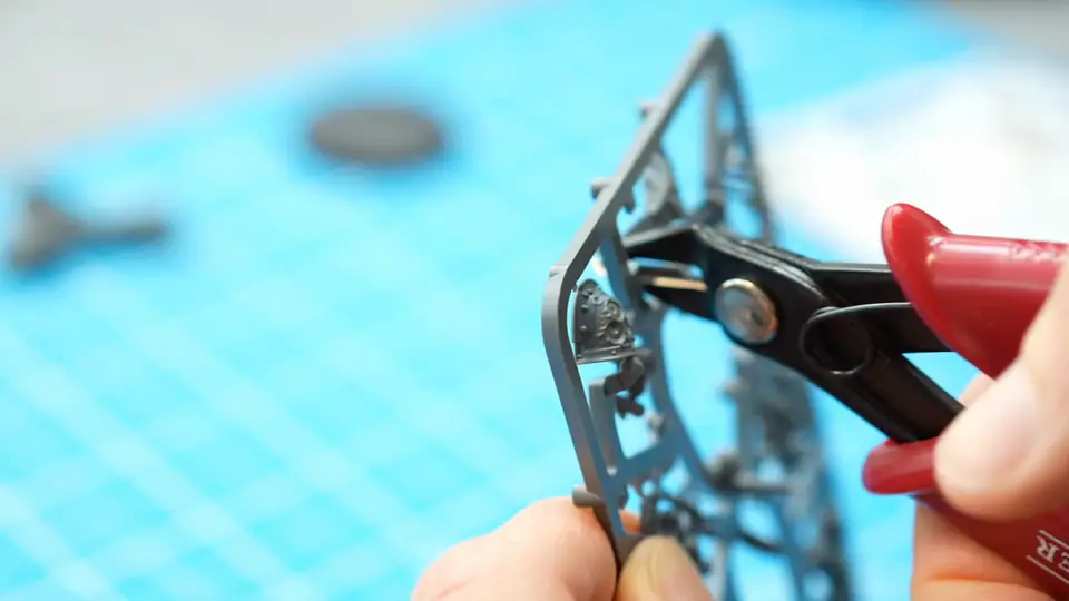 Clipping a part off the sprue with red-handled hobby clippers, Episode 02