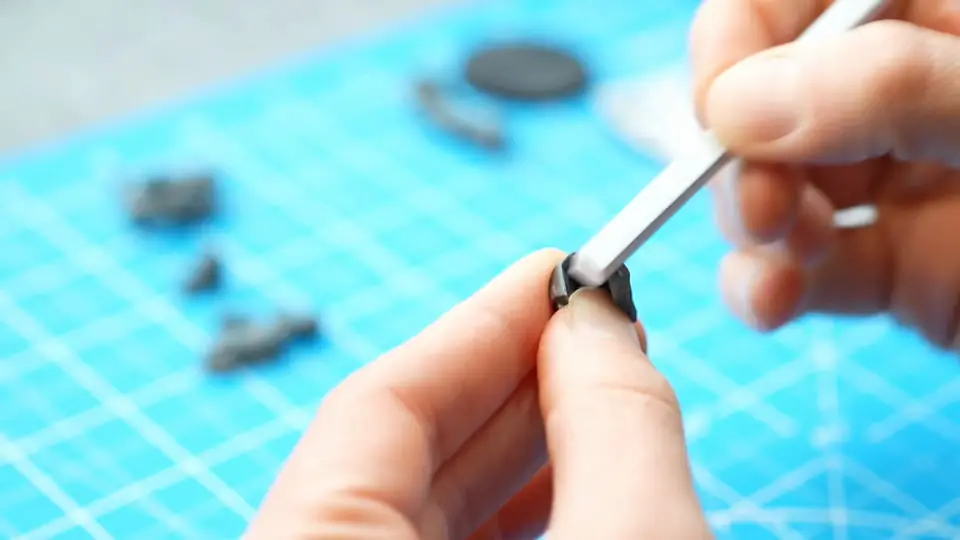 Smoothing a freshly clipped part with a hobby file before gluing, Episode 02