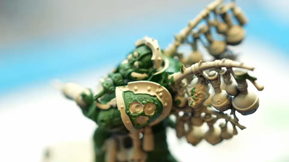 Her brush laying green highlights on the Putrifier's armour, Episode 02